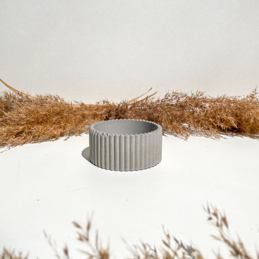 Petit pot strié en béton gris fabriqué à la main.