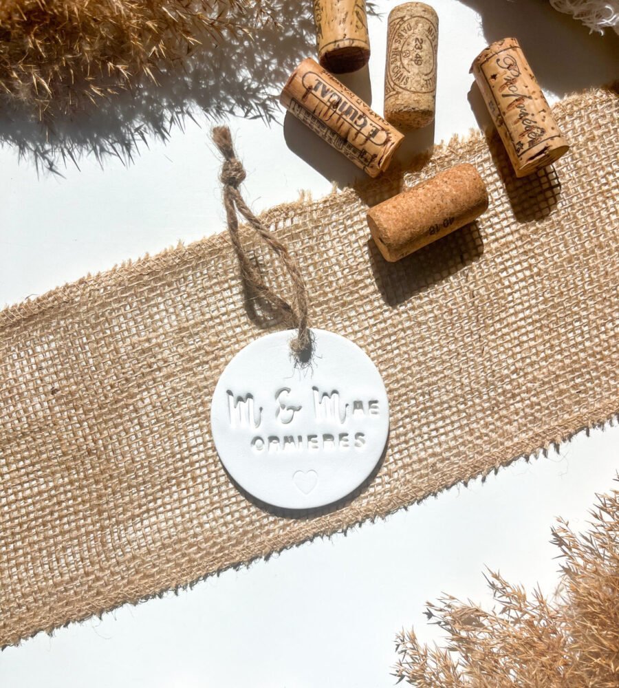 Ornement M&Mme personnalisé en argile avec fil de jute dans une mise en scène de mariage.